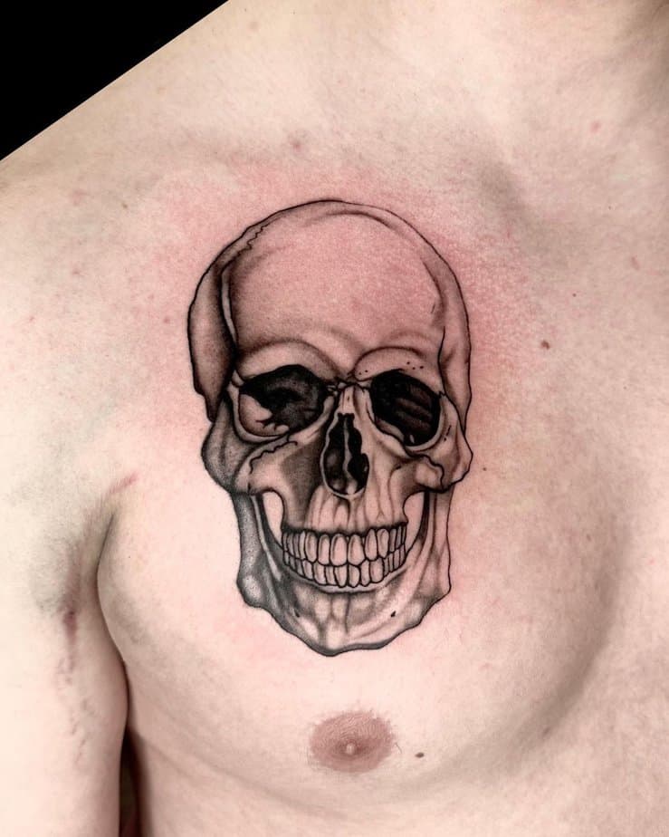 Skull-Themed Chest Tattoo with Bold Contrast