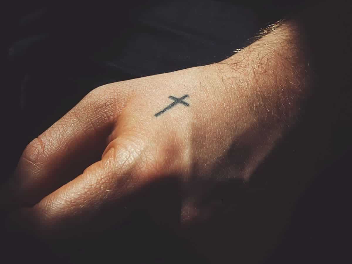 Cross Hand Tattoo with Bold Line Work